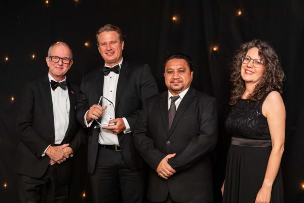 Michael Krumpelman and Ahmad Hafeez Ramli (centre) from BJ Services receive their award from ECITB CEO Andrew Hockey and event host Kate Bellingham